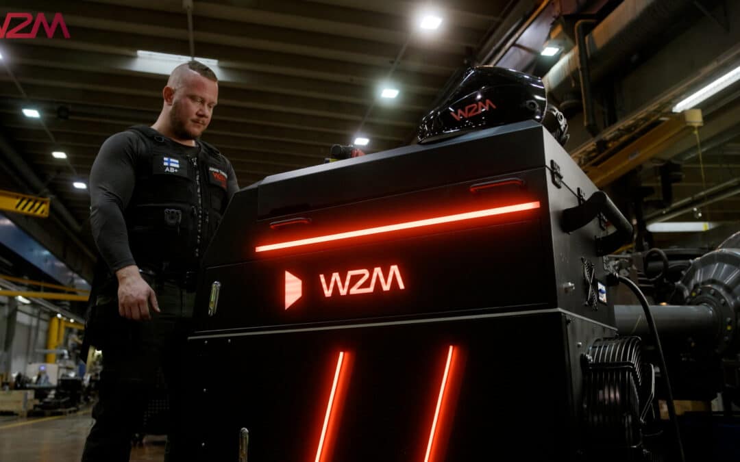 W2M-laserpuhdistuslaite ja sen käyttäjä teollisuushallissa.